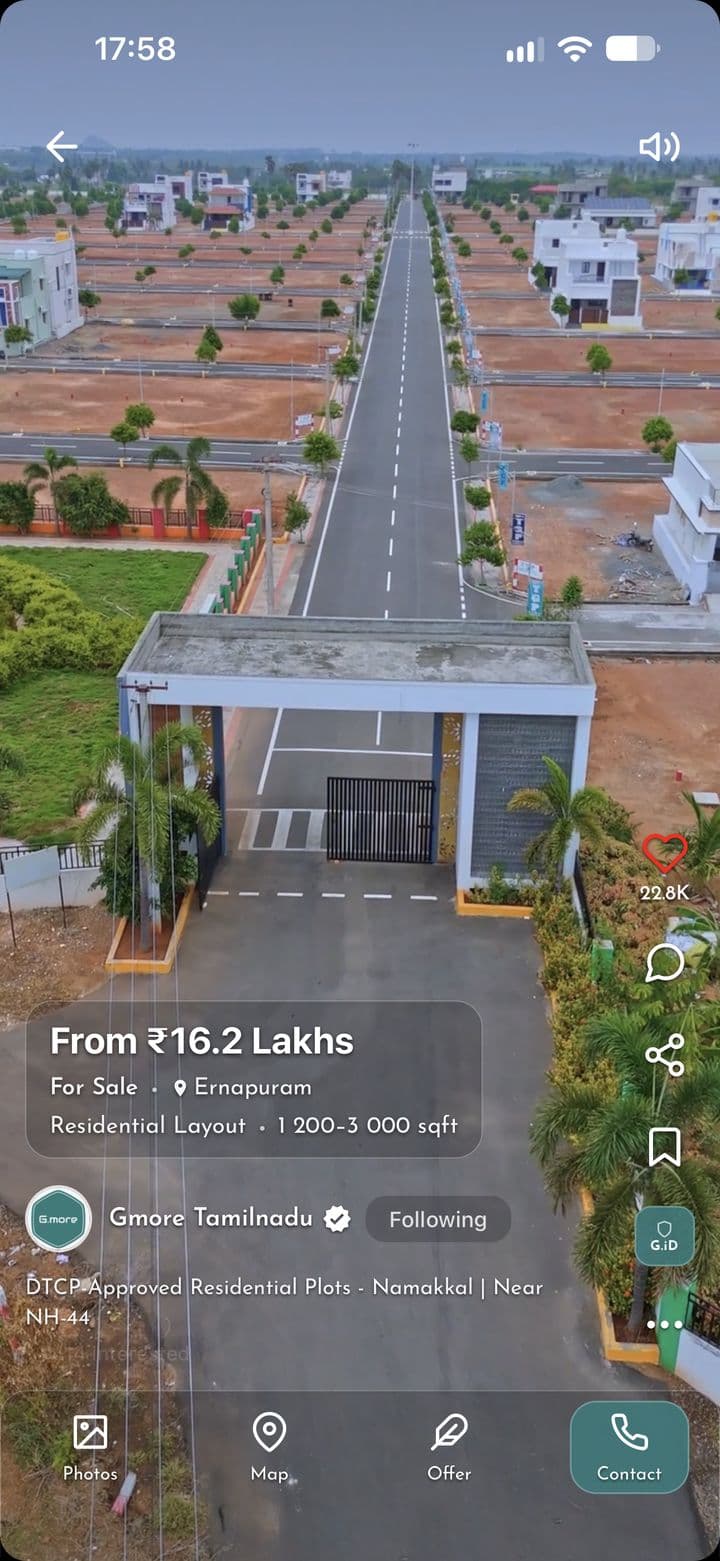 An aerial video of a residential layout for sale on Gmore, with its gate and main road, as buyers see it in the app