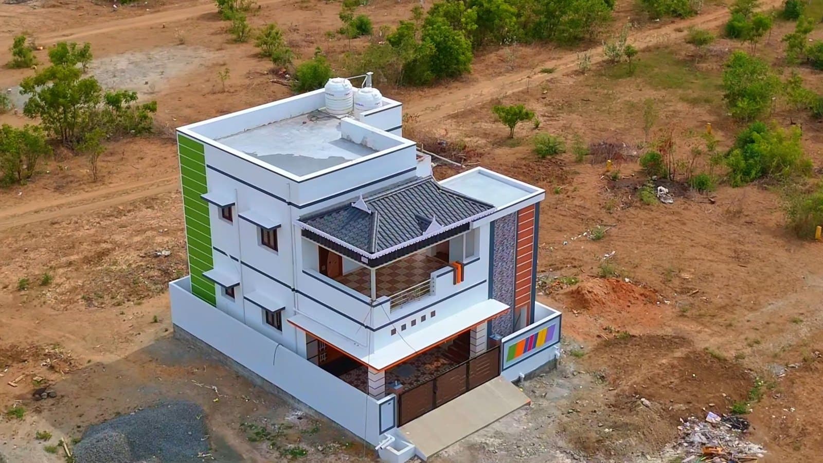 A new house in a growing layout in Tamil Nadu, filmed from the air by Gmore